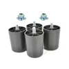 A set of four plastic furniture feet and two metal t-nuts on a white background. Náhled obrázku produktu