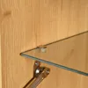 Close-up of a glass shelf supported by a metal bracket attached to a wooden surface. Anteprima dell’immagine prodotto