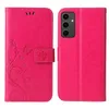 A pink flip phone case with a floral and butterfly embossed design is shown open, revealing the inside of the case and the phone it is designed for. Produktbild-Vorschau