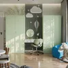 A child's room with light green wardrobes, a desk with a chair, and decorative elements on the wall. Podgląd zdjęcia produktu