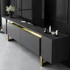 A modern TV stand with gold accents and decorative items on top. Anteprima dell’immagine prodotto