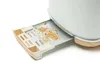 A close-up view of a toaster's crumb tray filled with crumbs. Produktbild-Vorschau