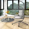 A hanging chair and small table are set up in a room with a large window overlooking a mountain landscape. Produktbild-Vorschau