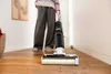 A person is using a Kärcher Saugwischer FCV 4 Dry Extra vacuum cleaner on a wooden floor. Produktbild-Vorschau