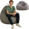 A young boy is sitting on a large beanbag chair, with another beanbag chair visible in the background. Voir les images du produit