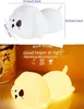 A white dog-shaped LED night light is shown with dimensions, and then a glowing yellow version of the same light is shown with marketing text. Produktbild-Vorschau