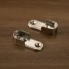 Two silver closet rod holders are shown on a wooden surface. Produktbild-Vorschau