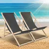 Two grey deck chairs on a sandy beach with the ocean in the background. Anteprima dell’immagine prodotto