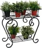 A black metal plant stand with multiple tiers, holding several potted plants. Produktbild-Vorschau