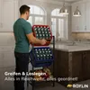 A man is holding a red crate of water bottles in a kitchen. Produktbild-Vorschau