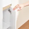 A hand is shown opening a cabinet door, revealing a hinge and a shelf inside. Náhľad obrázku produktu