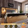 A modern bedroom with a large bed featuring a storage compartment and integrated lighting. Podgląd zdjęcia produktu