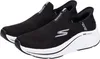 A pair of black Skechers slip-on sneakers with white soles, shown from a slightly elevated side angle against a white background. Náhled obrázku produktu