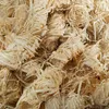 A close-up, overhead view of a pile of wood wool fire starters. Produktbild-Vorschau