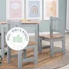 A child's table and chairs set in a room with children's artwork on the wall. Produktbild-Vorschau