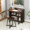 A compact desk and stool set placed near a window, with books and decor on the shelves. Anteprima dell’immagine prodotto