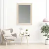 A stylish living room scene featuring a decorative mirror, armchair, and side table. Produktbild-Vorschau