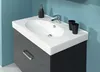 A bathroom vanity with a sink and faucet against a blue wall. Náhled obrázku produktu