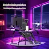 A person is sitting at a gaming desk with a computer and a drone on display, in a room with purple and pink lighting. Voir les images du produit