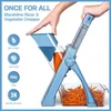 A hand is using a blue mandoline slicer and vegetable chopper to cut a carrot into julienne strips, which fall into a clear container. Voir les images du produit