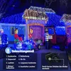A house decorated with blue and white Christmas lights, featuring a red toy truck and figures. Produktbild-Vorschau