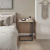A bedside table next to a bed in a bedroom. Produktbild-Vorschau