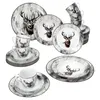 A collection of dinnerware with a stag motif, including plates, bowls, and cups, arranged on a white background. Voir les images du produit