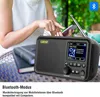 A person is using a smartphone while a portable DAB+ radio is on a table. Produktbild-Vorschau