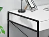 A close-up view of a white desk with black metal framing, showing a lamp and a picture frame on its surface. Voir les images du produit