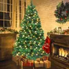 A decorated Christmas tree with presents underneath, next to a fireplace with a stocking hanging on it. Produktbild-Vorschau