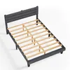 A dark gray upholstered bed frame with a slatted wooden base, shown from a diagonal angle against a white background. Produktbild-Vorschau