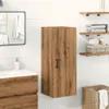 A bathroom scene with a wooden cabinet, sink, mirror, and shelves. Produktbild-Vorschau