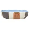 A multi-colored ceramic bowl with a blue speckled interior and striped exterior. Produktbild-Vorschau