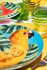 A close-up of a table setting with colorful tropical-themed plates and glasses. Anteprima dell’immagine prodotto