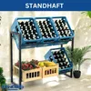 A metal shelving unit displaying blue crates filled with bottles on the top shelf and wooden crates filled with fruits and vegetables on the bottom shelf. Náhled obrázku produktu