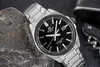 A close-up shot of a silver Casio Edifice watch with a black dial, placed on a dark, textured surface next to a rock. Voir les images du produit