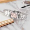A close-up shot of a silver Casio watch with a pink face, resting on a marble surface next to a book. Produktbild-Vorschau