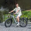 A man is riding an electric bicycle outdoors. Produktbild-Vorschau
