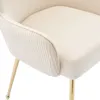 A close-up view of a cream-colored armchair with gold legs. Produktbild-Vorschau