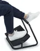 A person's legs and feet are shown using a black footrest. Náhľad obrázku produktu