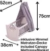 A doll's cradle with a canopy, mattress, and blanket, showing dimensions and included items. Produktbild-Vorschau