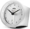 A white Braun radio-controlled alarm clock is shown from a slightly angled side view against a white background. Voir les images du produit