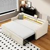 A beige sofa bed is shown in a room setting, with a rug on the floor and a window with blinds in the background. Voir les images du produit