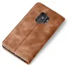 A brown leather flip case for a smartphone, shown from the back with the camera cutout visible. Produktbild-Vorschau