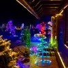 A yard decorated with numerous Christmas lights and illuminated spiral trees at night. Anteprima dell’immagine prodotto