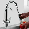 A person is washing an apple under a kitchen faucet. Náhled obrázku produktu