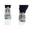 Two views of a person wearing Nike Air Vapormax 2021 FK SE shoes, shown from the back. Voir les images du produit