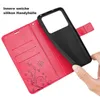 A hand is holding a black phone case over a red wallet-style phone case with card slots and floral embossing. Produktbild-Vorschau