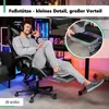 A man is sitting in a gaming chair with his feet up on a footrest, demonstrating a feature of the chair. The image includes a close-up inset showing the dimensions of the footrest. Produktbild-Vorschau