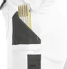 A close-up view of a white and gray work pant pocket with a folding ruler inserted. Produktbild-Vorschau